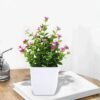 6e90c9c9-4b48-467a-b553-a8c8740add24.8d82be07fb60a4b50d8fc00755907784_converted.jpg Small Artificial Potted Plant with Flowers – Green